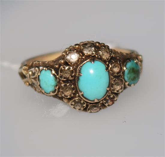 A Victorian turquoise and white stone cluster ring in openwork yellow metal setting, size P.